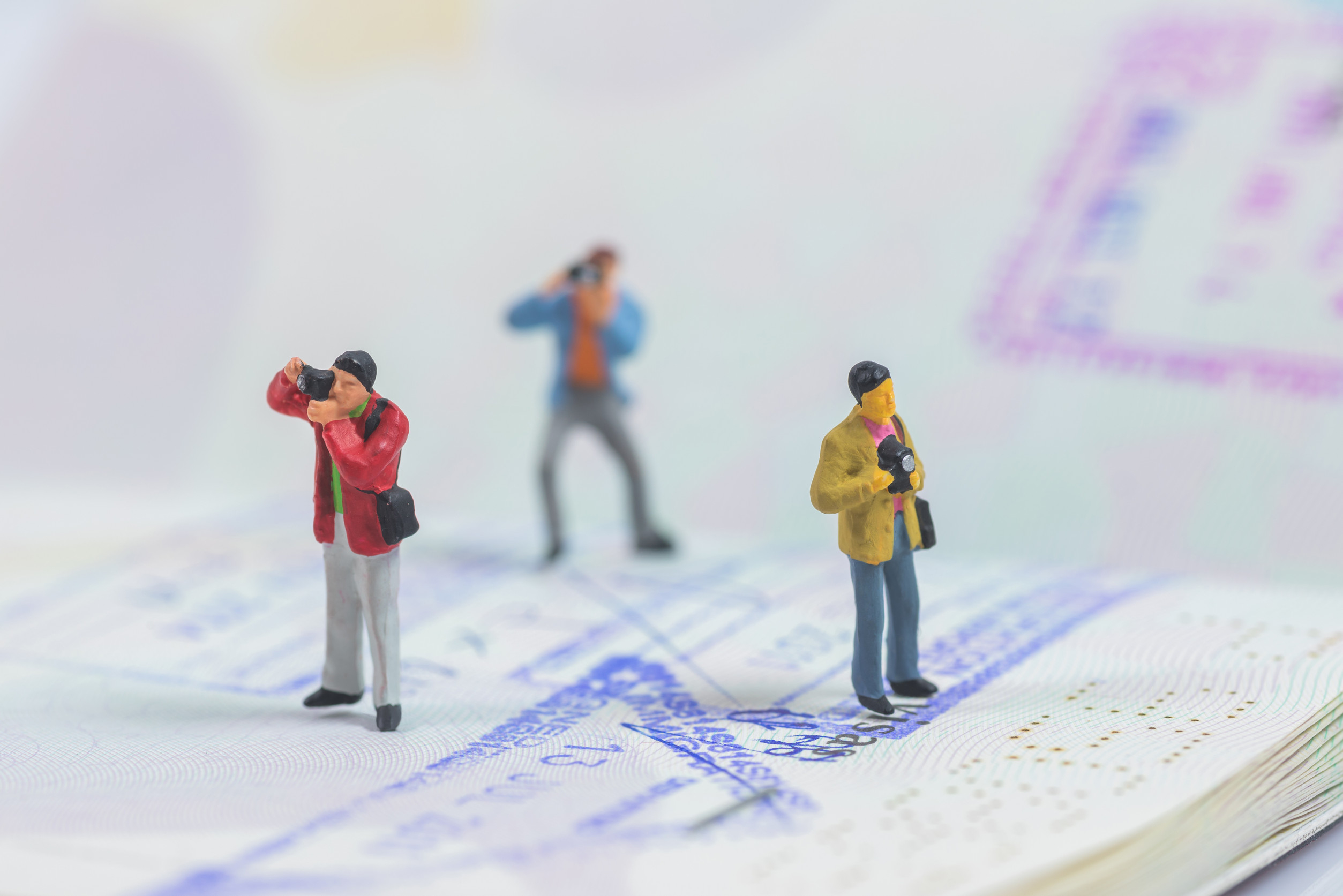 Miniature Photographers On A Passport Book